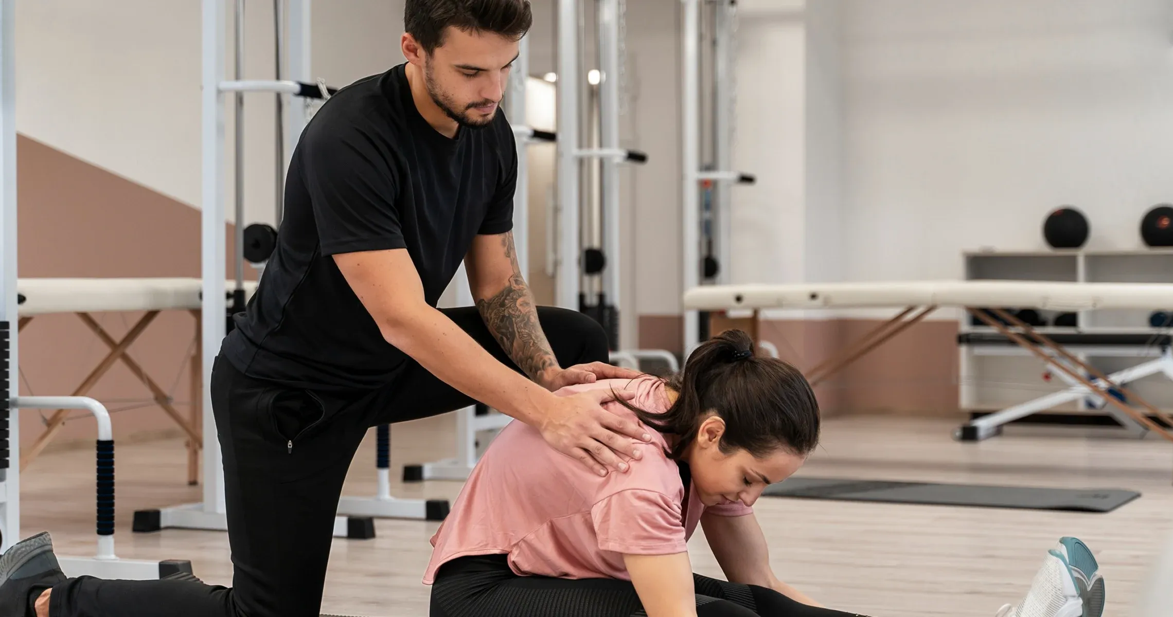 A therapist guiding a patient through a mobility exercise