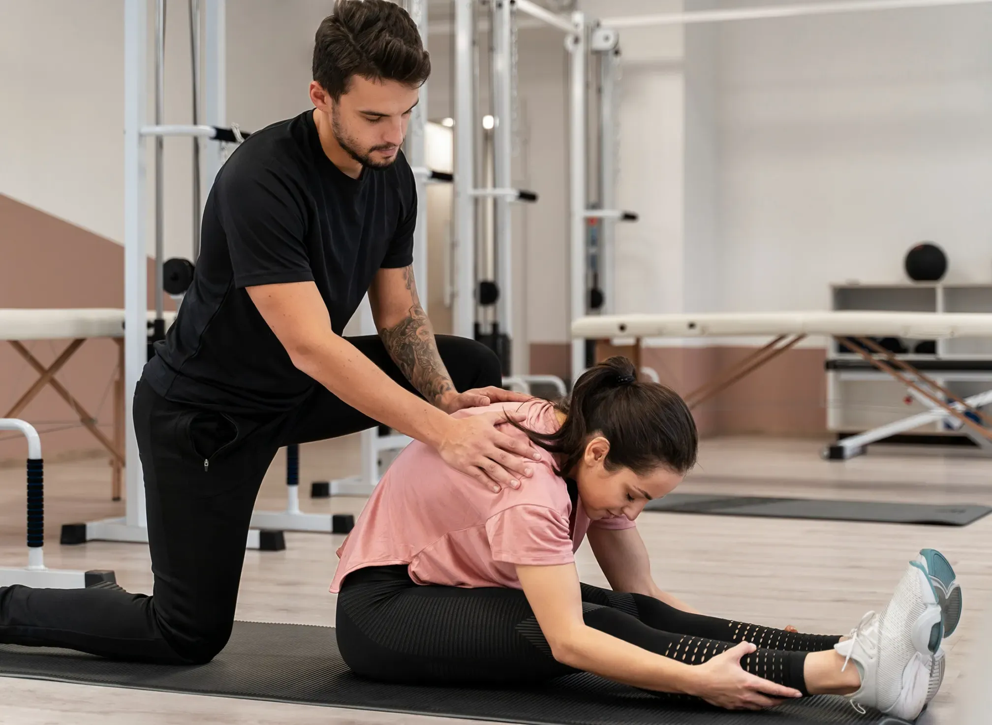 A therapist guiding a patient through a mobility exercise